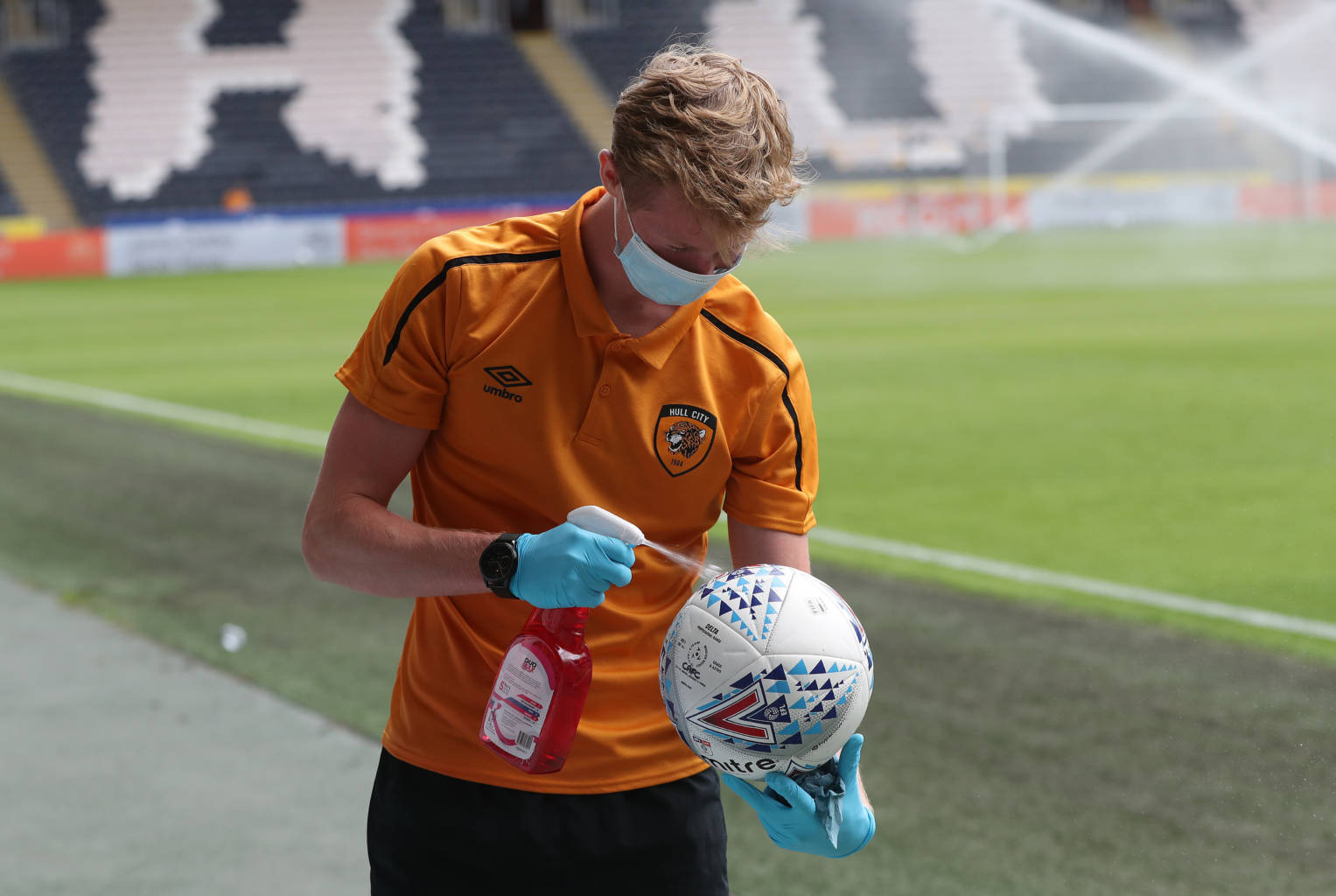 HULL, ENGLAND - JUNE 20:  A ball ball disinfects the ball prior to during the Sky Bet Championship match between Hull City and Charlton Athletic at KCOM Stadium on June 20, 2020 in Hull, England.  Football Stadiums around Europe remain empty due to the Coronavirus Pandemic as Government social distancing laws prohibit fans inside venues resulting in all fixtures being played behind closed doors.  (Photo by David Rogers/Getty Images)