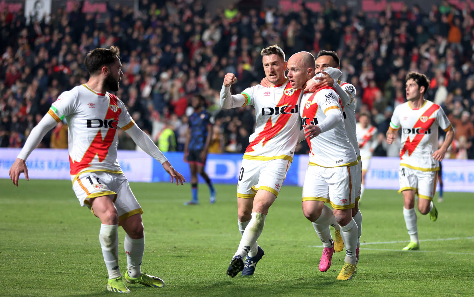 MADRID, SPAIN - FEBRUARY 05: Isi Palazon of Rayo Vallecano celebrates scoring his team's first goal with teammates during the LaLiga EA Sports match between Rayo Vallecano and Sevilla FC at Estadio de Vallecas on February 05, 2024 in Madrid, Spain. (Photo by Florencia Tan Jun/Getty Images)
